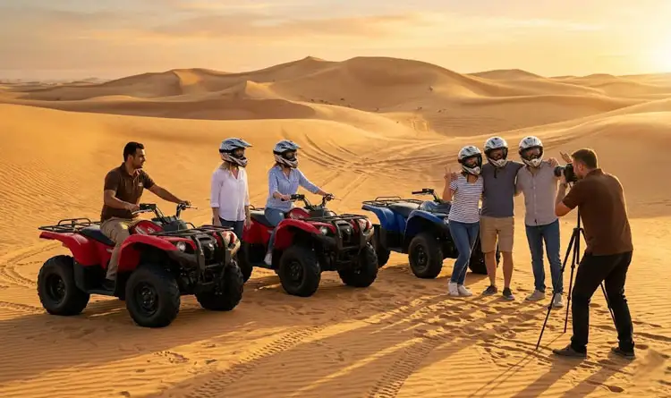 A tour guide taking a photo of tourists standing on a sand dune next to their ATVs during a group quad bike safari Abu Dhabi experience at sunrise.